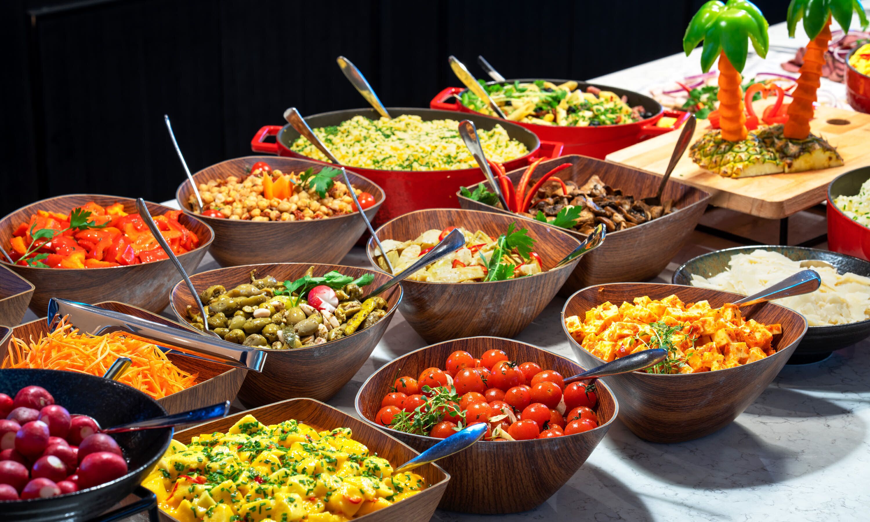 A variety of dishes in wooden bowls on a table.