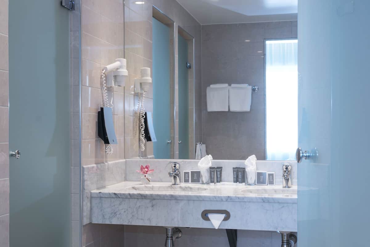 Eco-friendly toiletries, hair dryer, heated floors, towels