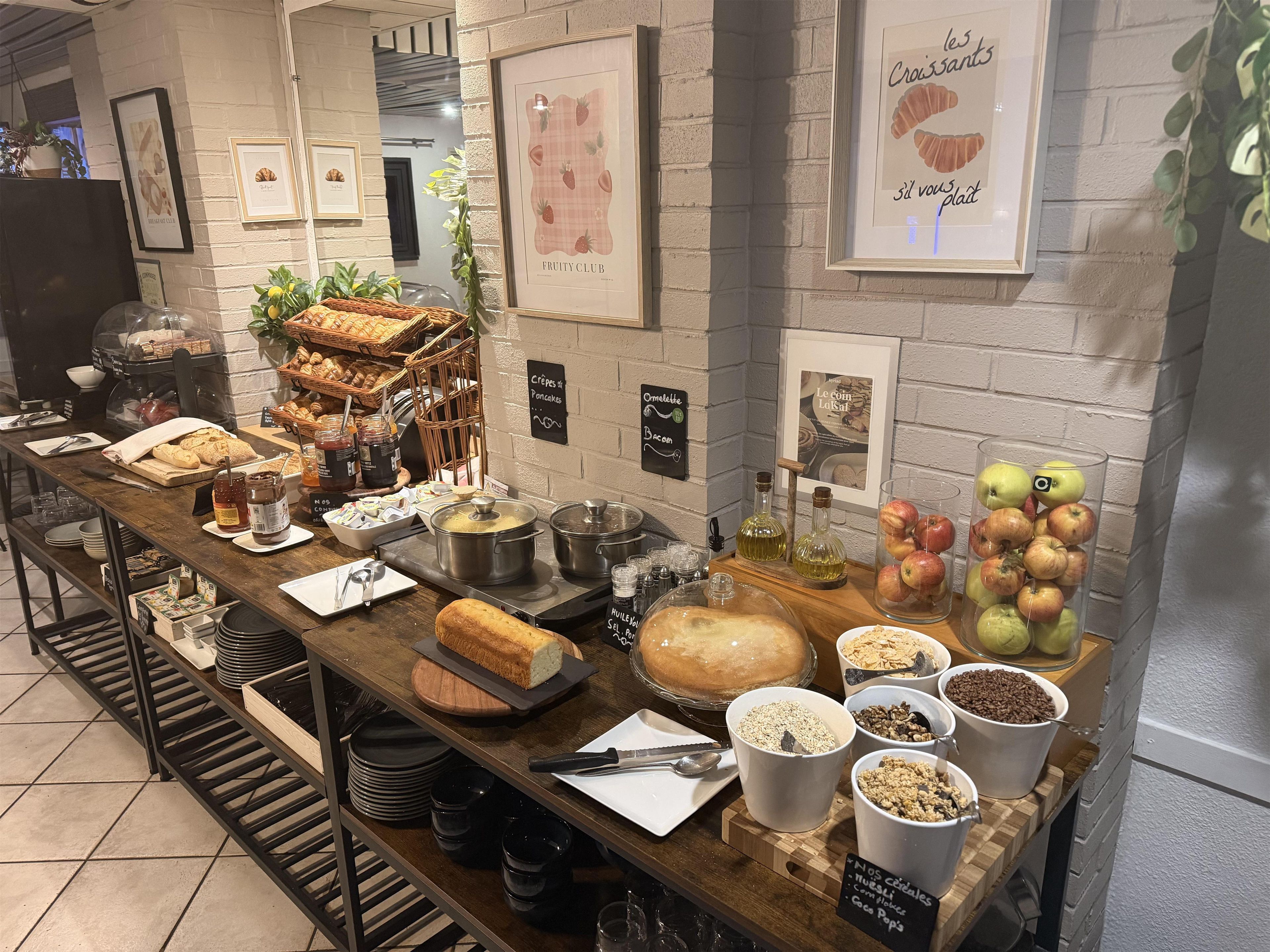 A buffet setup with various food items and condiments.