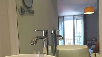 A bathroom with two sinks, a mirror, and toiletries.