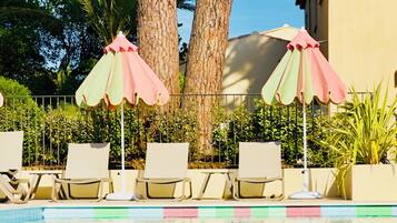 Seasonal outdoor pool, open 8:00 AM to 10:00 PM, pool umbrellas