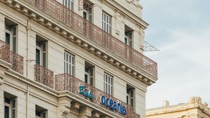 A multi-story building with ornate balconies and a dome on the top floor. - Escale Oceania Marseille Vieux Port (Marseille)