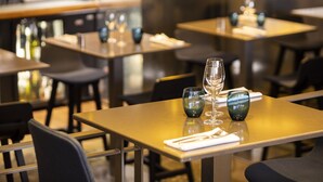 A restaurant interior with tables set for dining, featuring a bar area in the background. - Oceania Brest Centre (Brest)