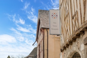 A building with a sign reading "Aux Vieux Remparts".
