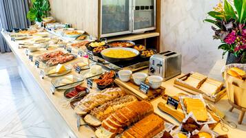 A buffet with various food items including bread, cheese, and meats.