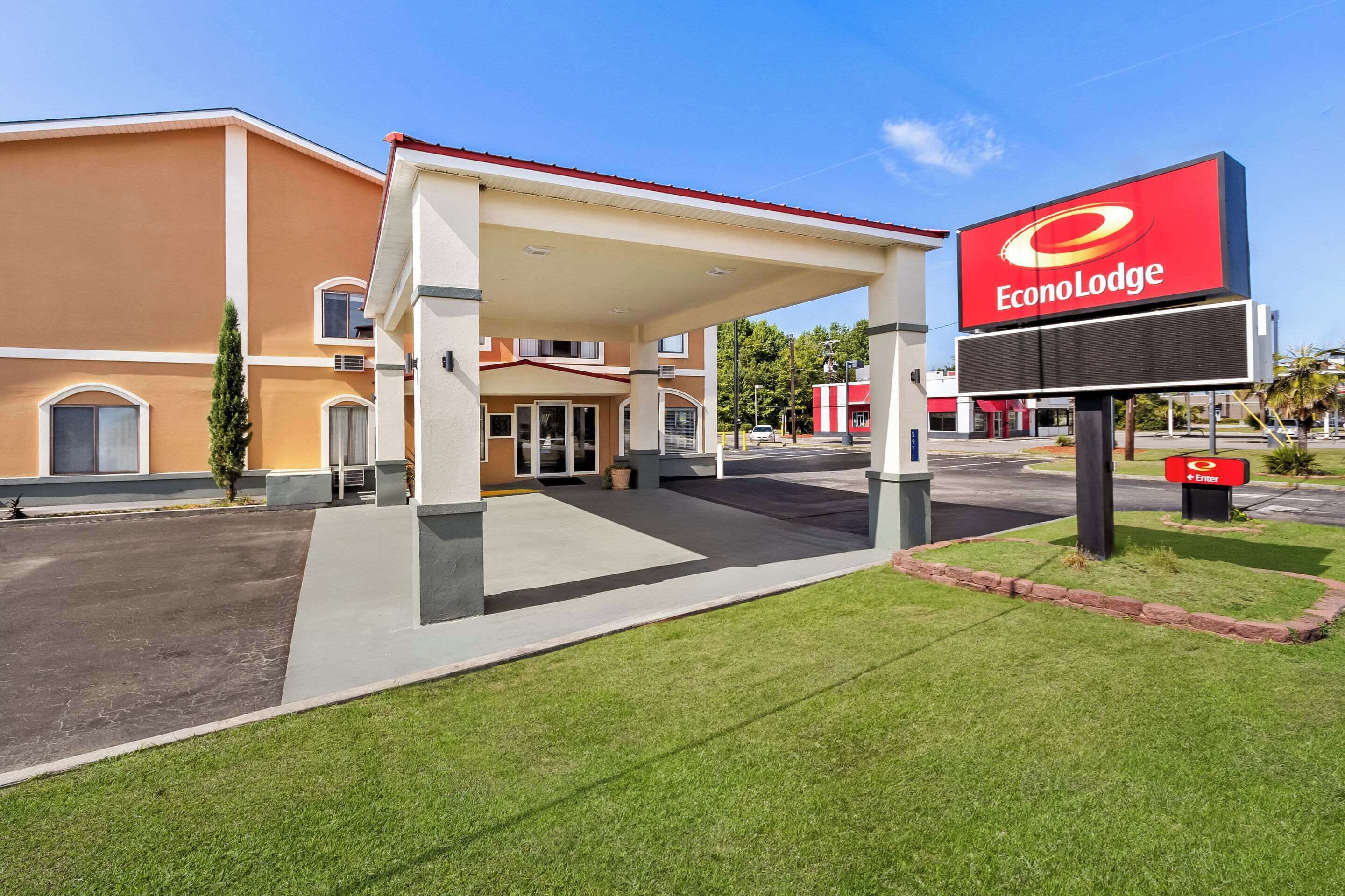 A gas station with a canopy and a large sign for EconoLodge.