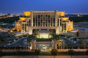 A large, modern building with a prominent entrance, multiple windows, and a well-lit facade. - Al Ahsa InterContinental by IHG (Al-Hofuf)