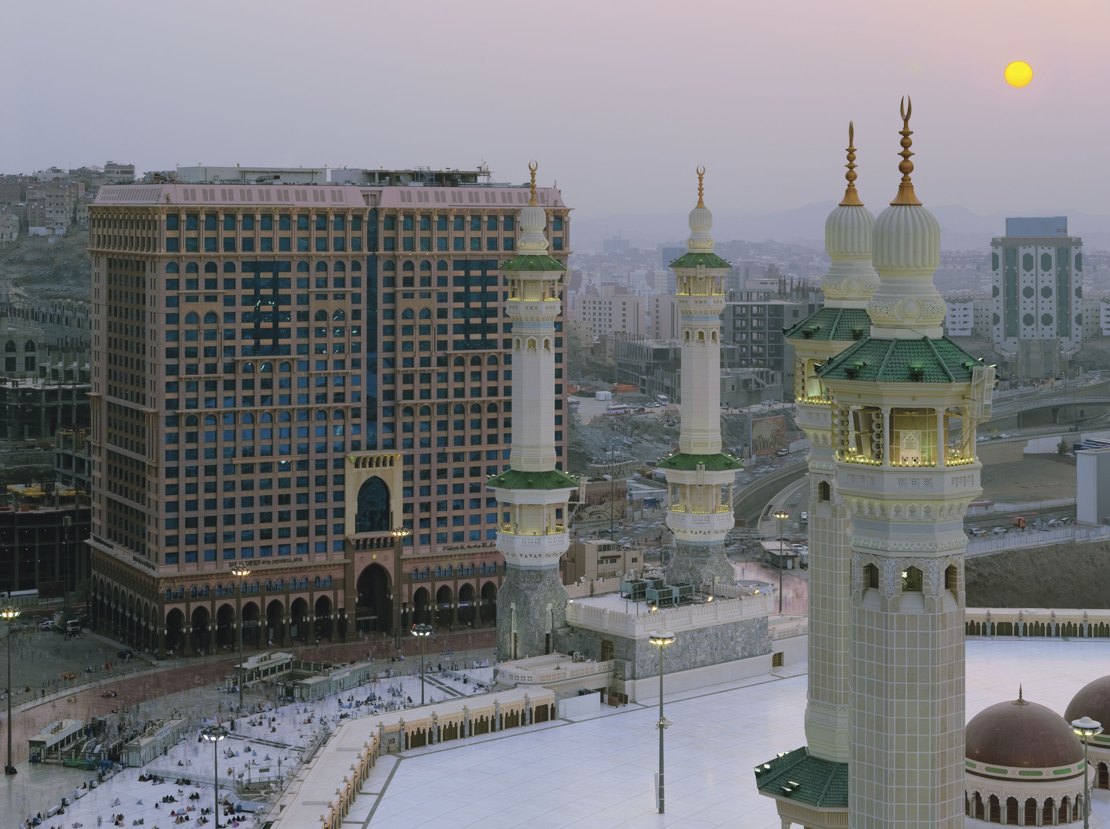 A large building with multiple floors and a prominent minaret.