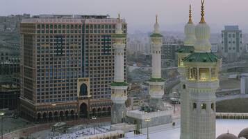 A large building with multiple floors and a prominent minaret.