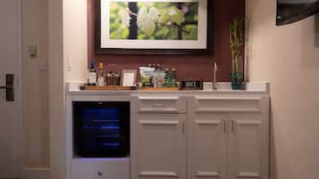A kitchen with a built-in oven, a framed picture above the counter, and a 'SNACK' sign.