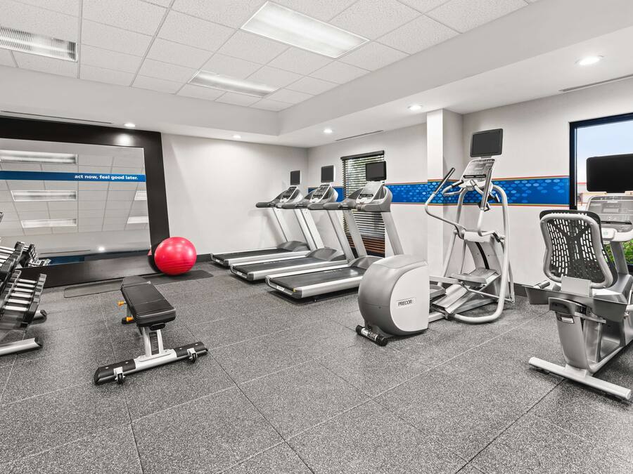 A gym with treadmills, stationary bikes, and weight machines.