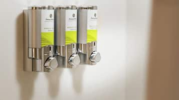 A wall-mounted dispenser with three compartments, each labeled 'Exotic Collection'.