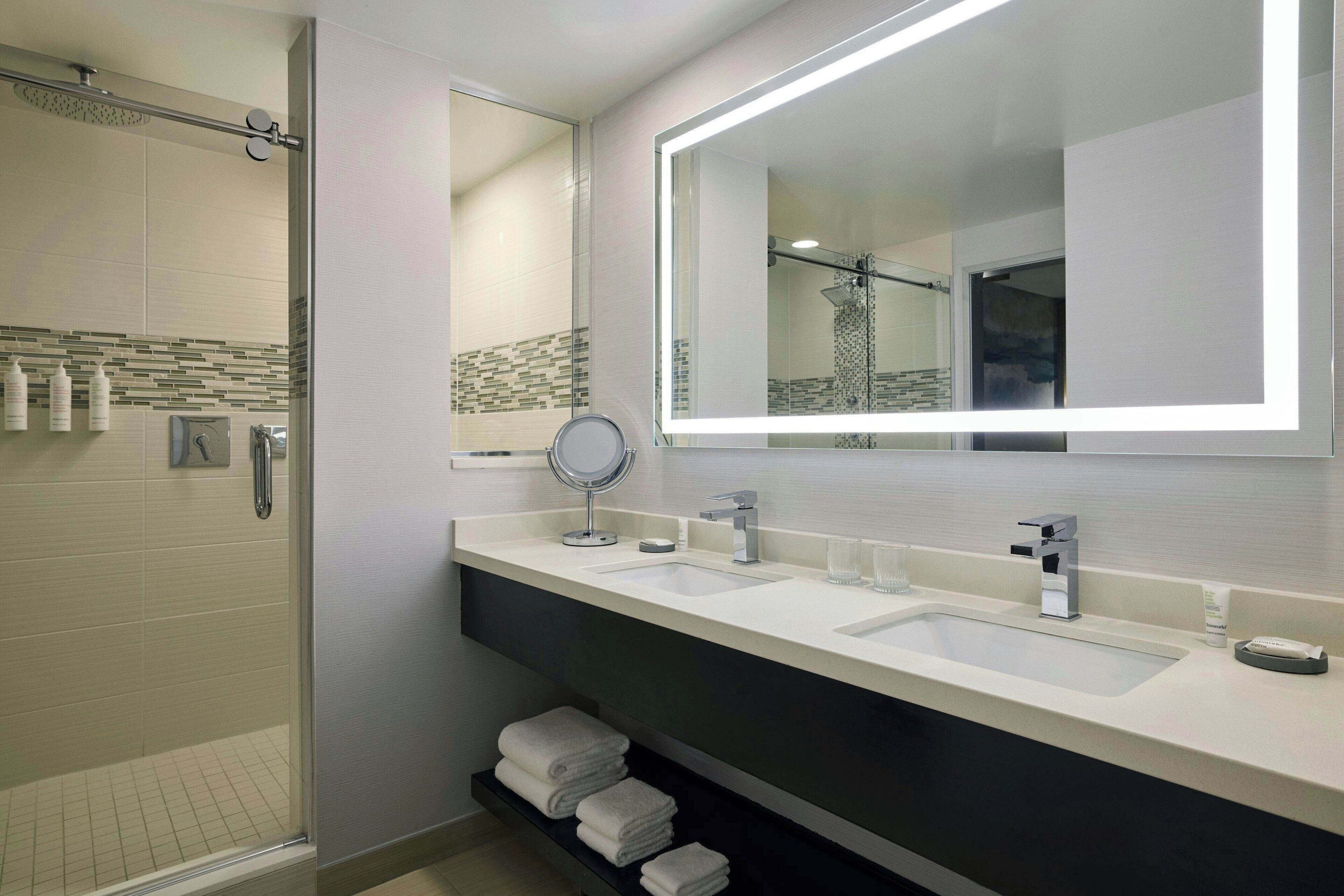 combined shower/bathtub, designer toiletries, hair dryer, towels