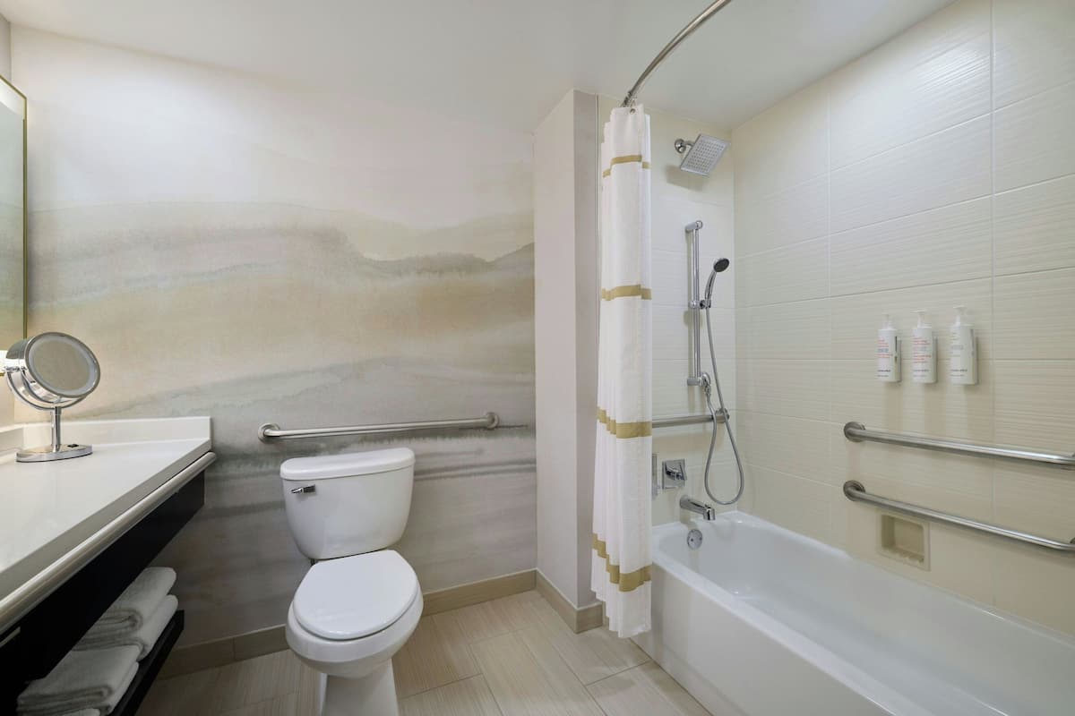 Combined shower/tub, designer toiletries, hair dryer, towels