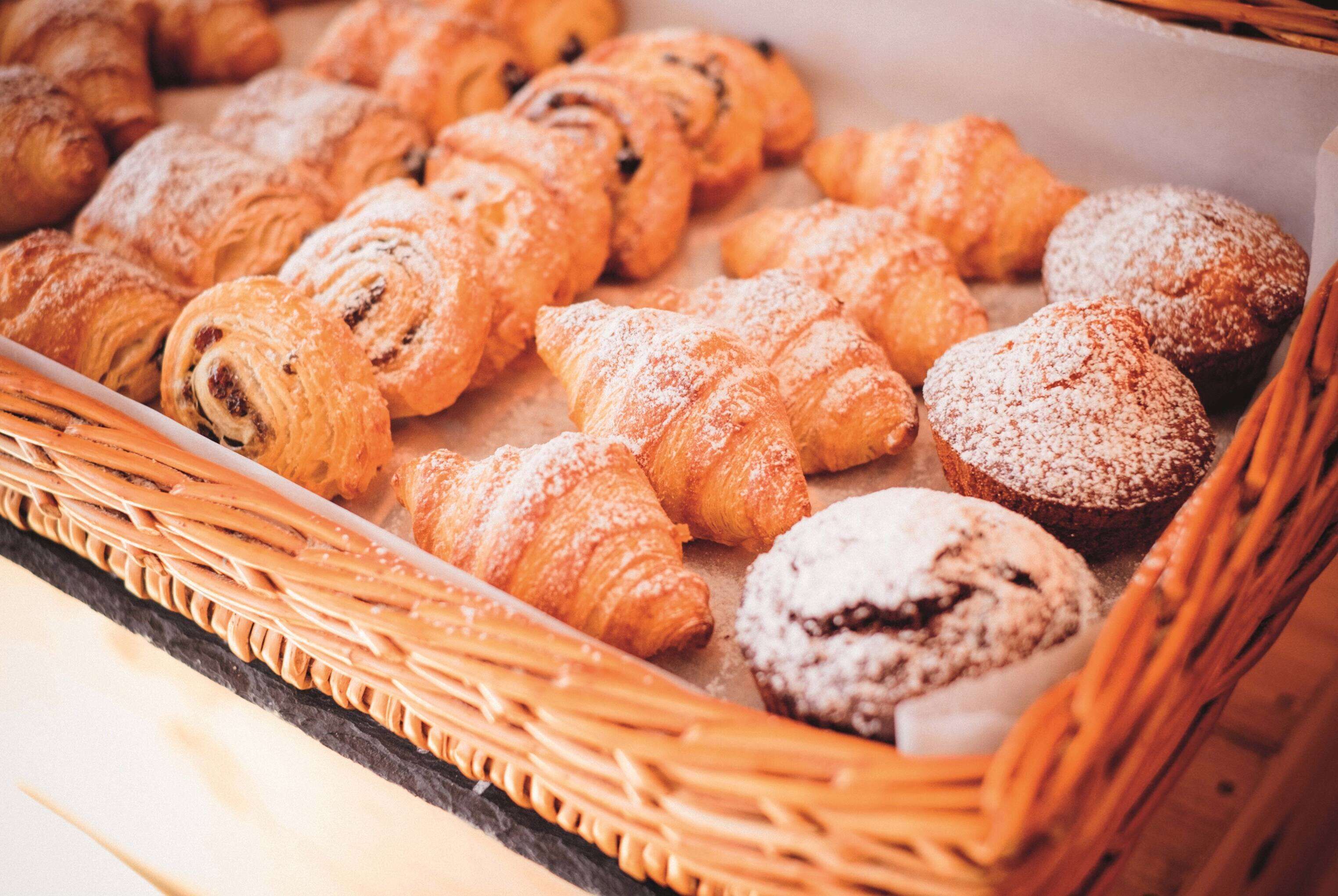 A variety of pastries in a wicker basket.