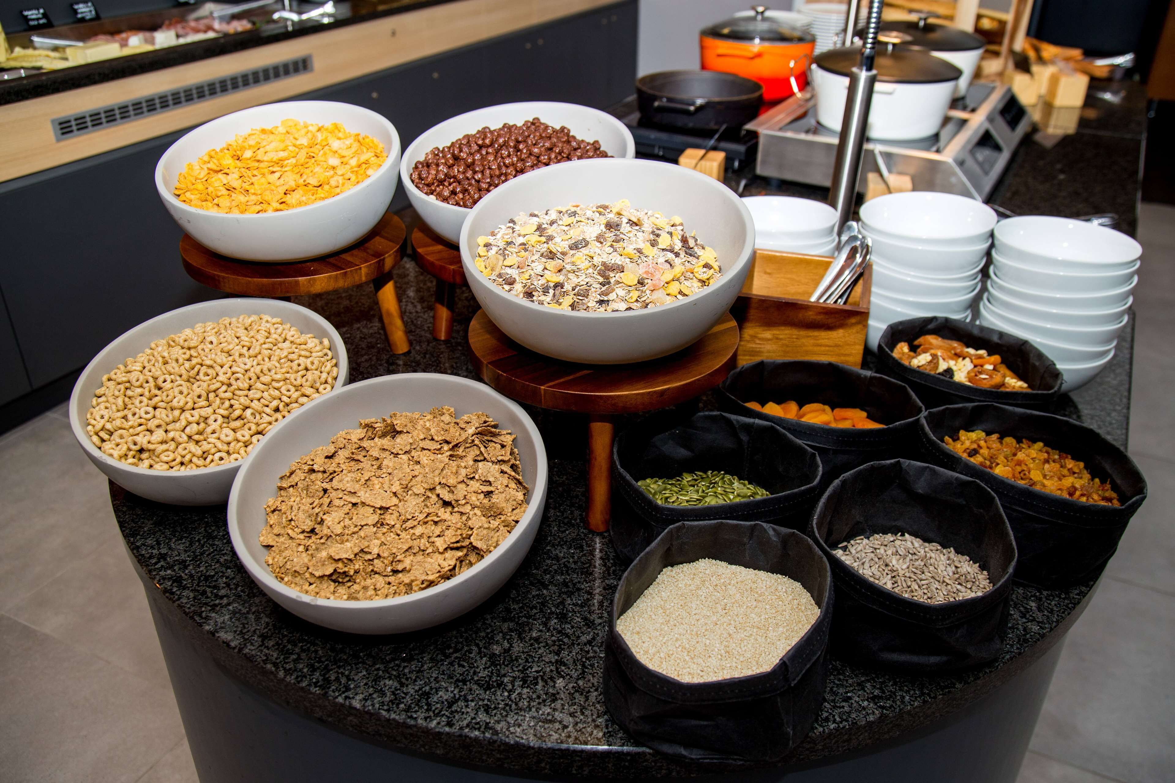 A buffet with various food items in bowls and containers.