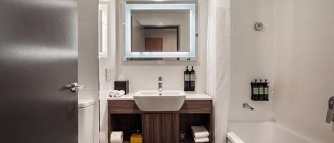 A modern bathroom with a sink, mirror, and shower.