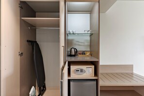 A compact kitchenette with a refrigerator, a coffee maker, and a kettle. - Sudima Christchurch Airport (Christchurch)