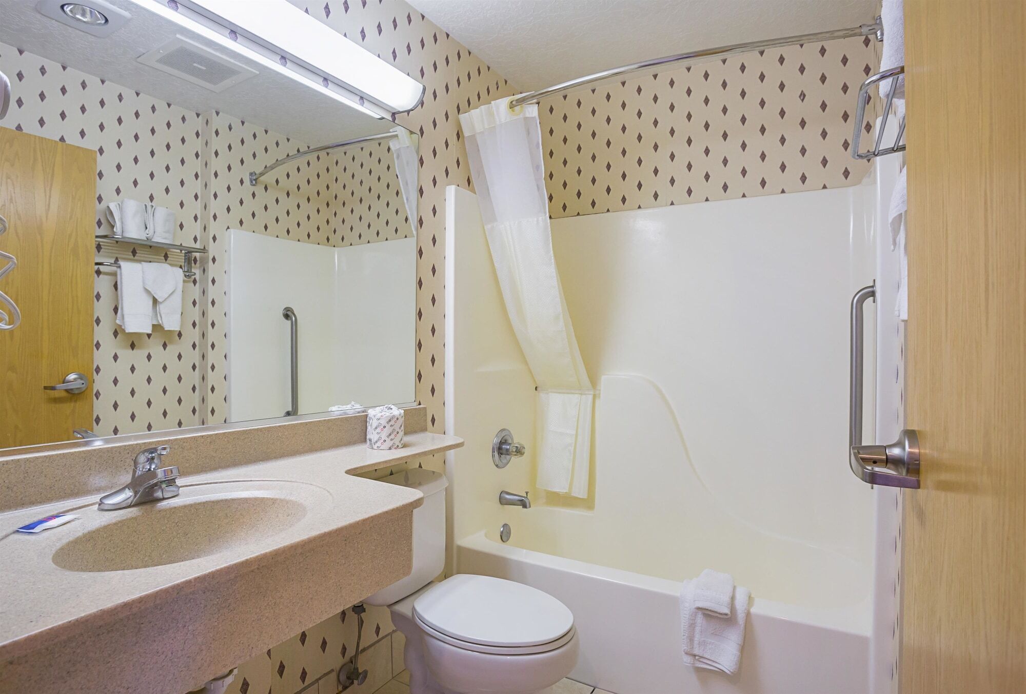 A bathroom with a sink, toilet, and bathtub.