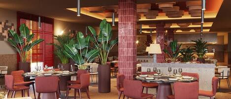 Un interior de restaurante moderno con mesas redondas, sillas rojas y lámparas colgantes.