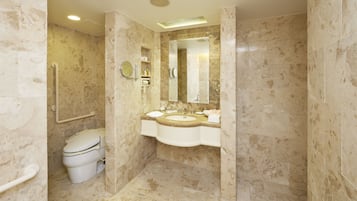 A bathroom with a toilet, sink, and mirror.