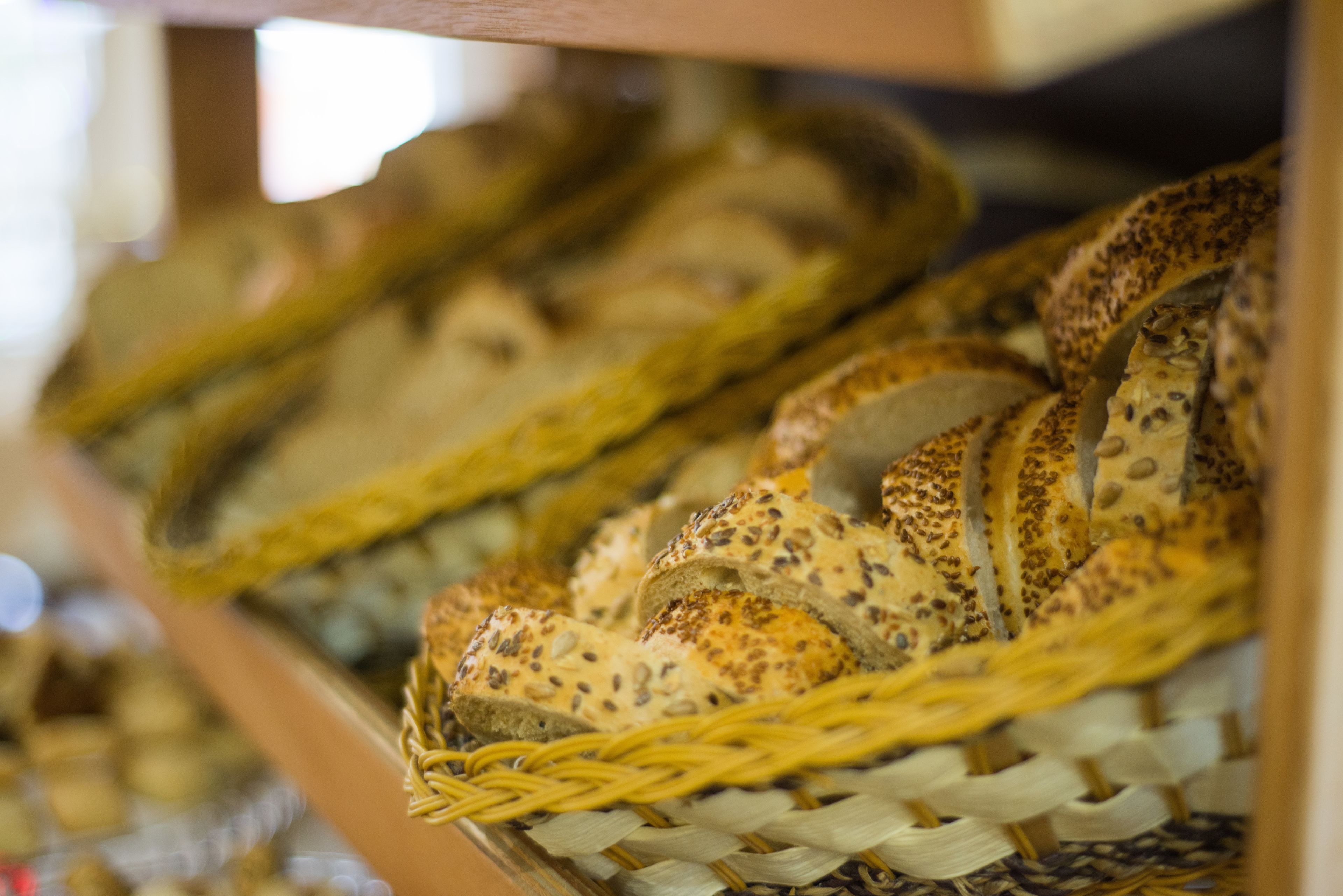 A display of various breads in a basket.