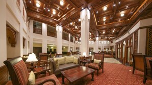 A spacious lobby with high wooden ceilings, multiple seating areas, and a patterned carpet. - Dar Es Salaam Serena Hotel (Dar es Salaam)