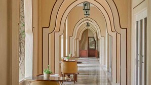 A corridor with arched ceilings, hanging lanterns, and a marble floor. - Gateway Aurangabad - Chhatrapati Sambhaji Nagar (Chhatrapati Sambhajinagar)