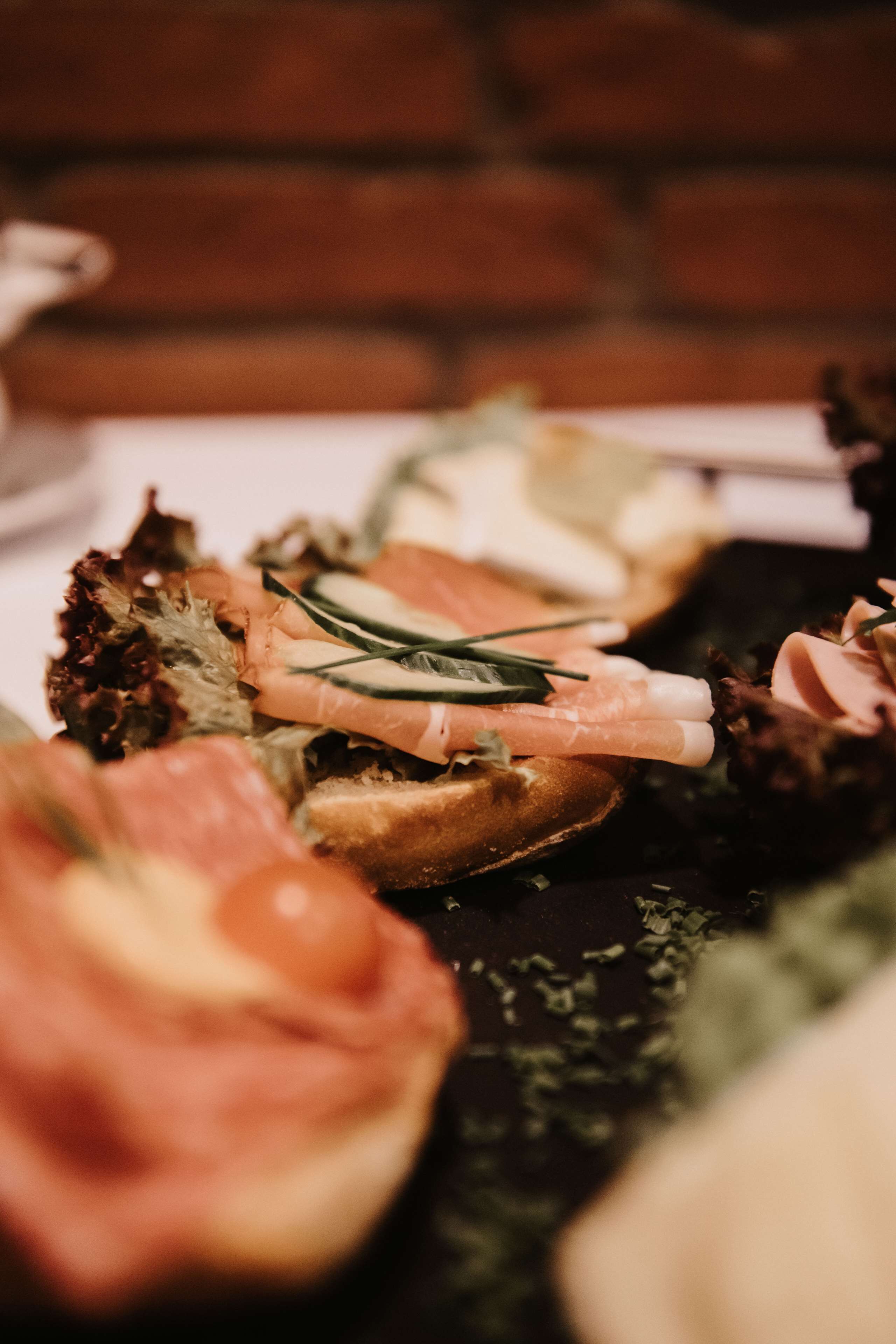 A close-up of a food platter with various meats and garnishes.