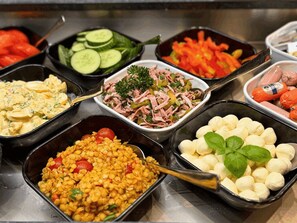 A buffet with various food options including salads, vegetables, and pasta. - Hotel Hohenstaufen (Koblenz)