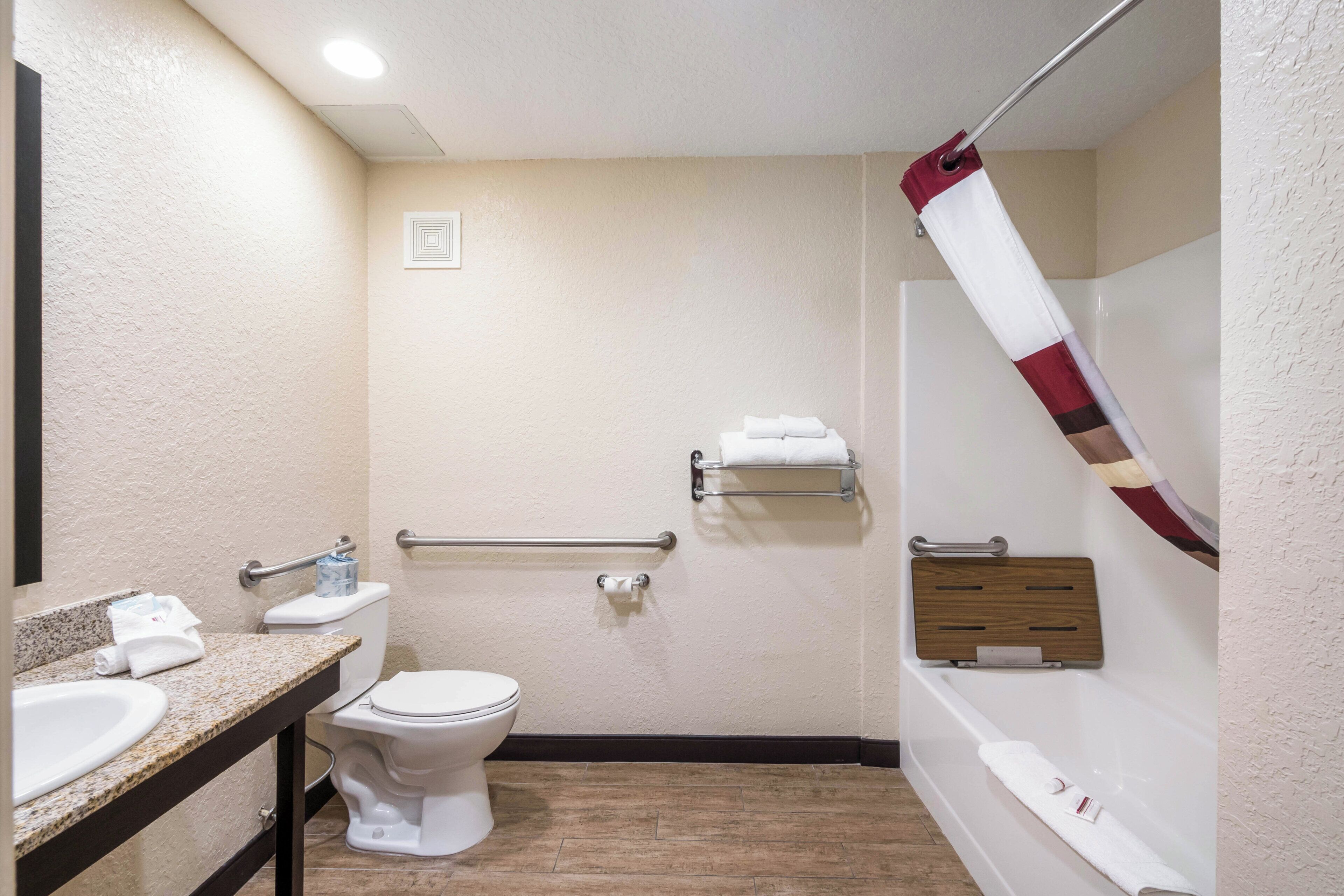 A bathroom with a toilet, sink, and bathtub.
