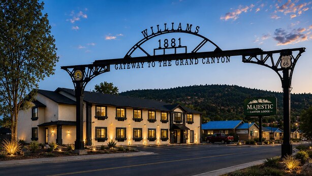 Un edificio con un letrero que dice 'Williams Gateway to the Grand Canyon 1881' y otro letrero para 'Majestic Canyon Lodge'.