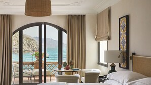 A hotel room with a bed, a table with chairs, a view of the sea, and a balcony. - Villa Sant'Andrea, A Belmond Hotel, Taormina Mare (Taormina)