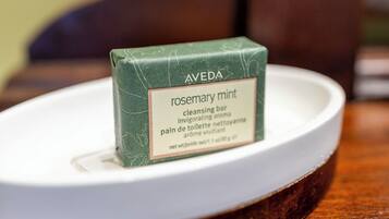 A bar of Aveda rosemary mint cleansing bar on a white plate.