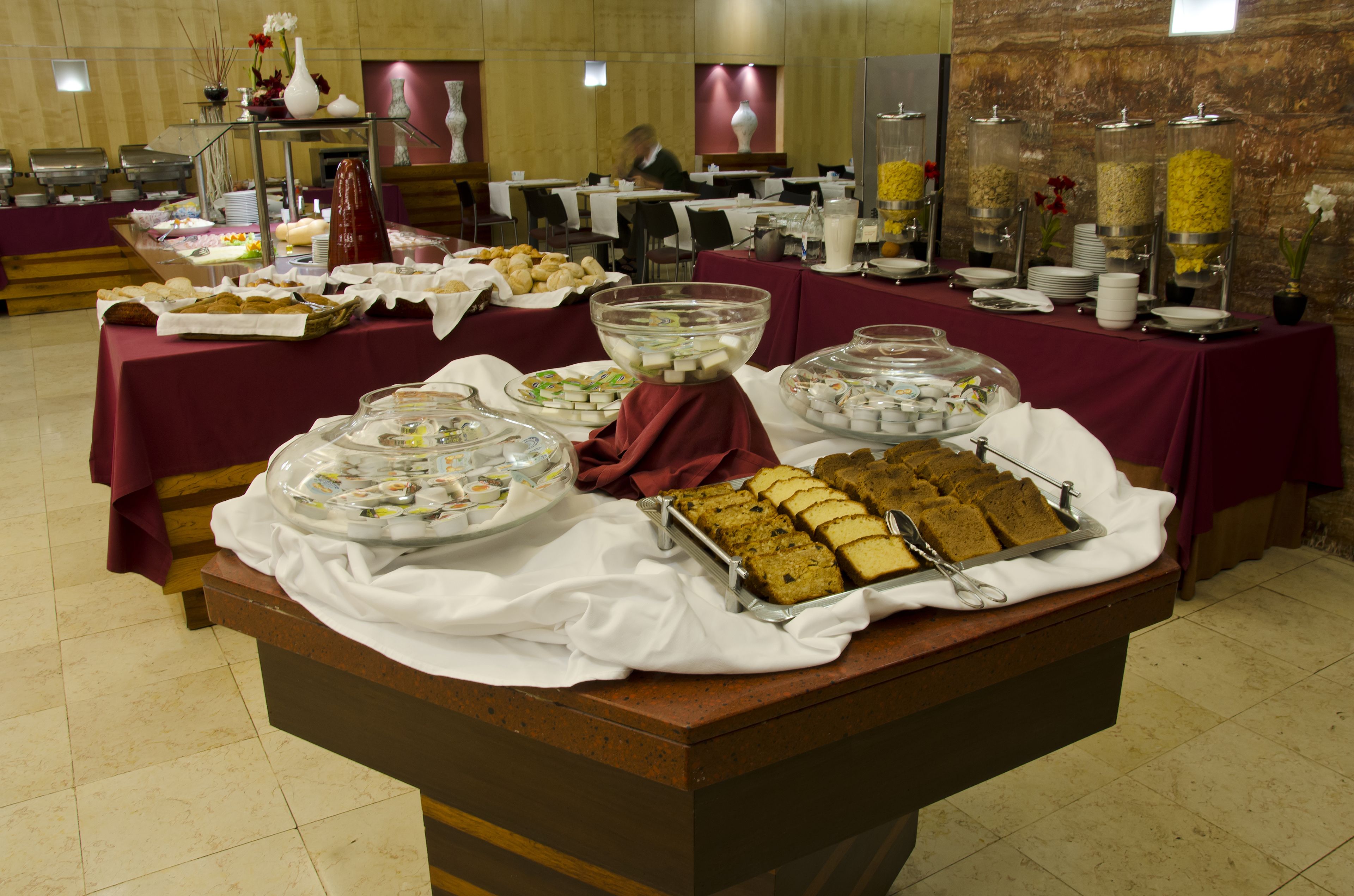 A buffet setup with various food items and serving dishes.