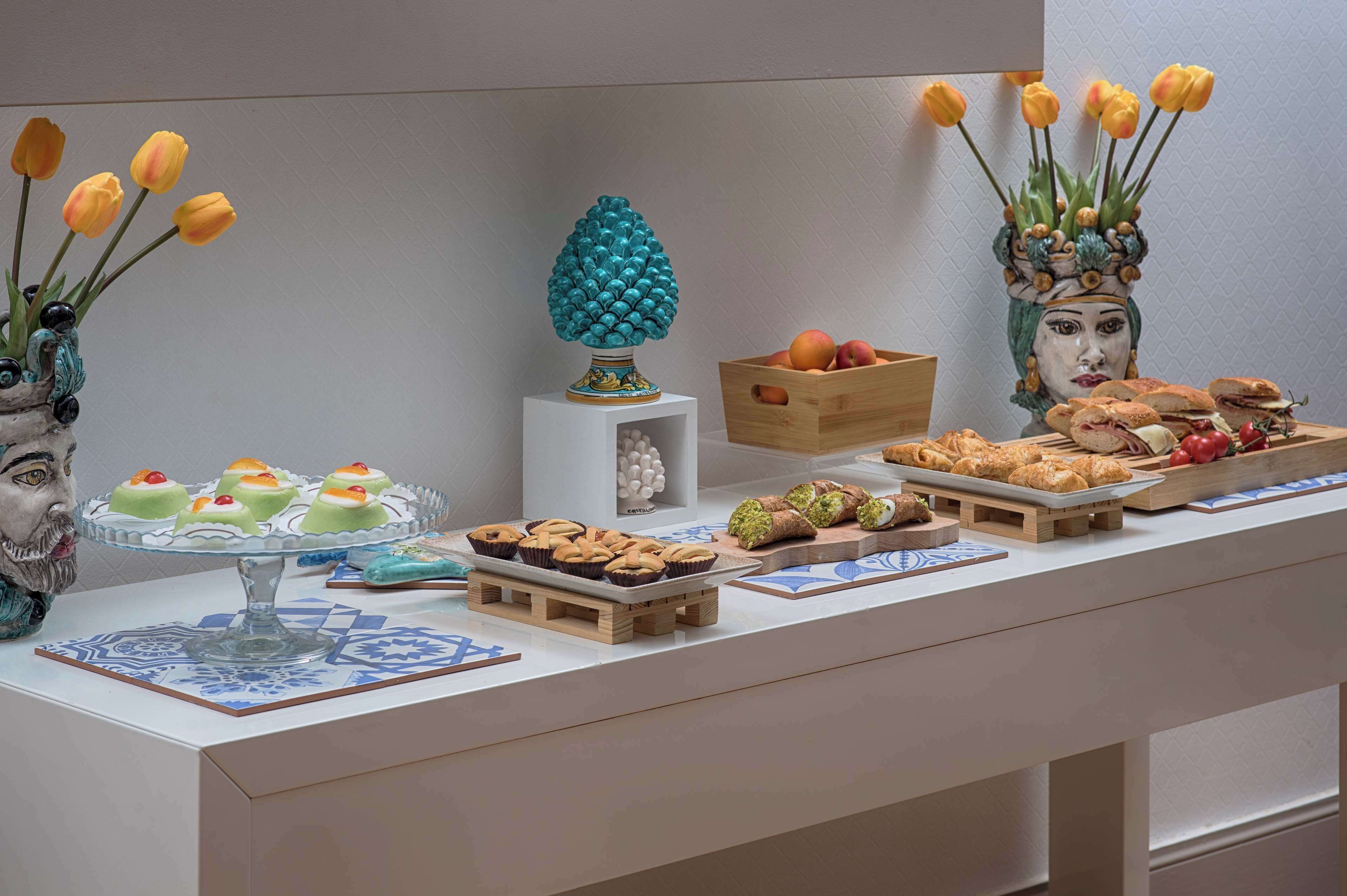 A buffet table with various food items and decorative elements.