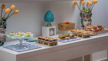 A buffet table with various food items and decorative elements.