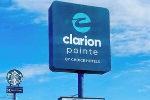 A hotel sign for Clarion Pointe by Choice Hotels.