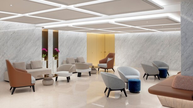 A modern lounge area with sofas and armchairs arranged around a central coffee table.