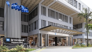 A modern hotel entrance with a covered walkway, large windows, and a sign for Wyndham Singapore Hotel. - Wyndham Singapore Hotel (Singapore)