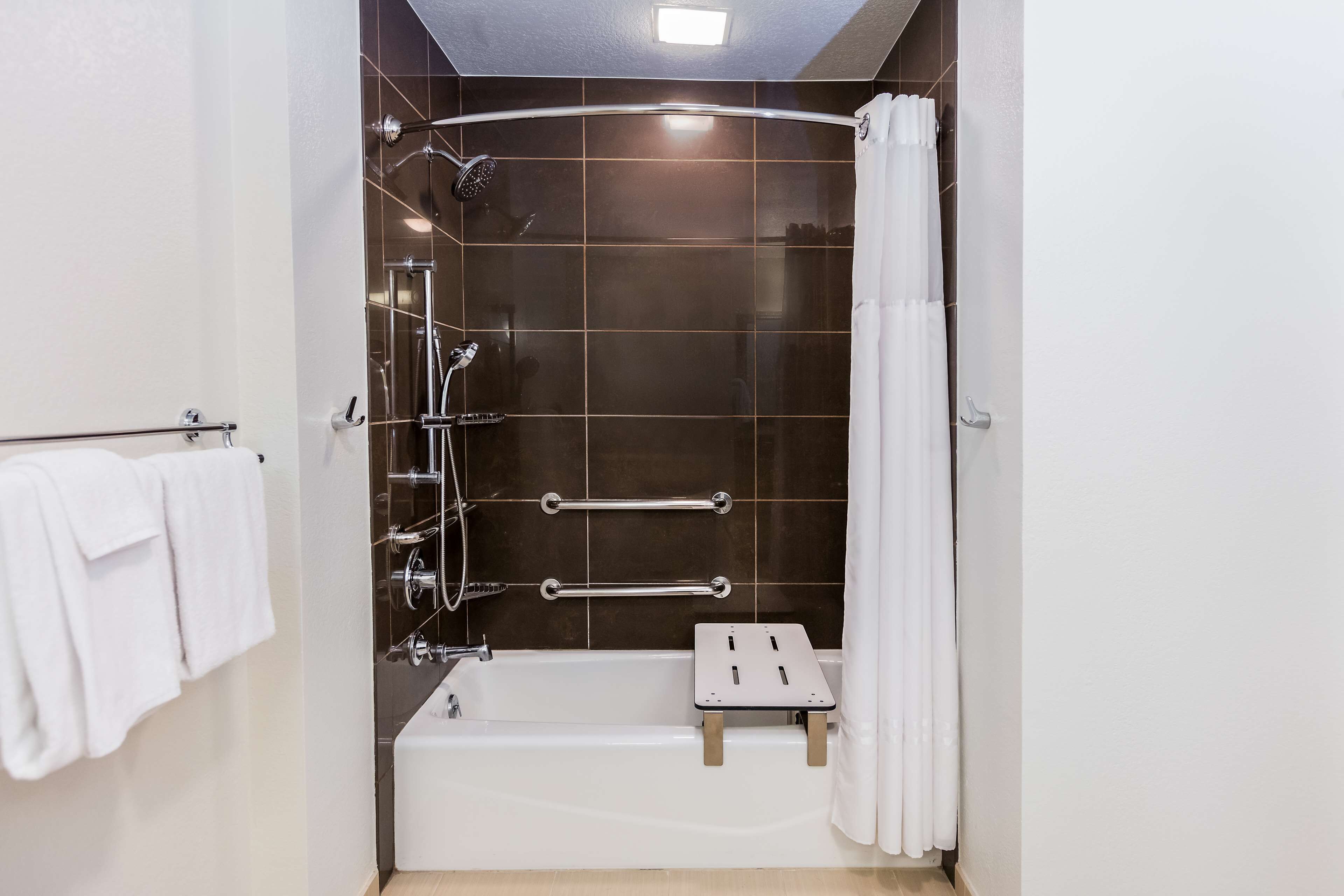 studio suite, 1 king bed, accessible (shower) | bathroom | designer toiletries, hair dryer, towels