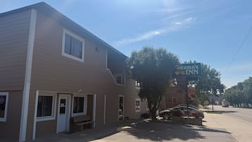 A two-story building with a sign for 'Tennant's Inn' on the corner.