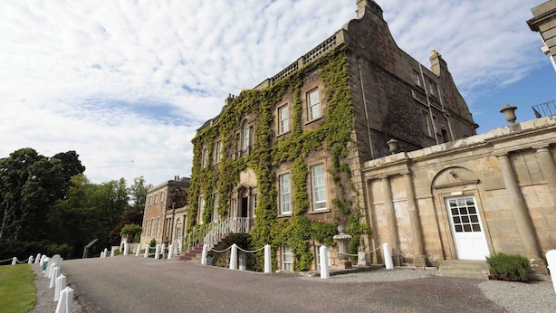 A historic building with ivy-covered walls, a grand entrance, and a paved driveway. - Culloden House Hotel (Inverness)