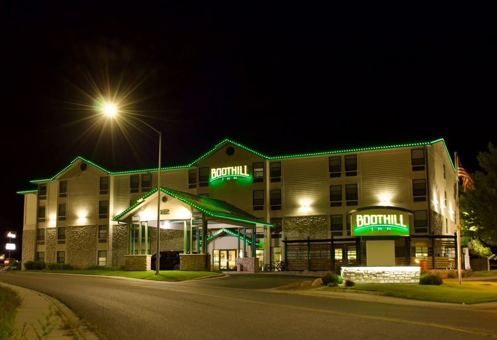 A multi-story building with a prominent 'BOOTHILL INN' sign, featuring a stone facade and a covered entrance.