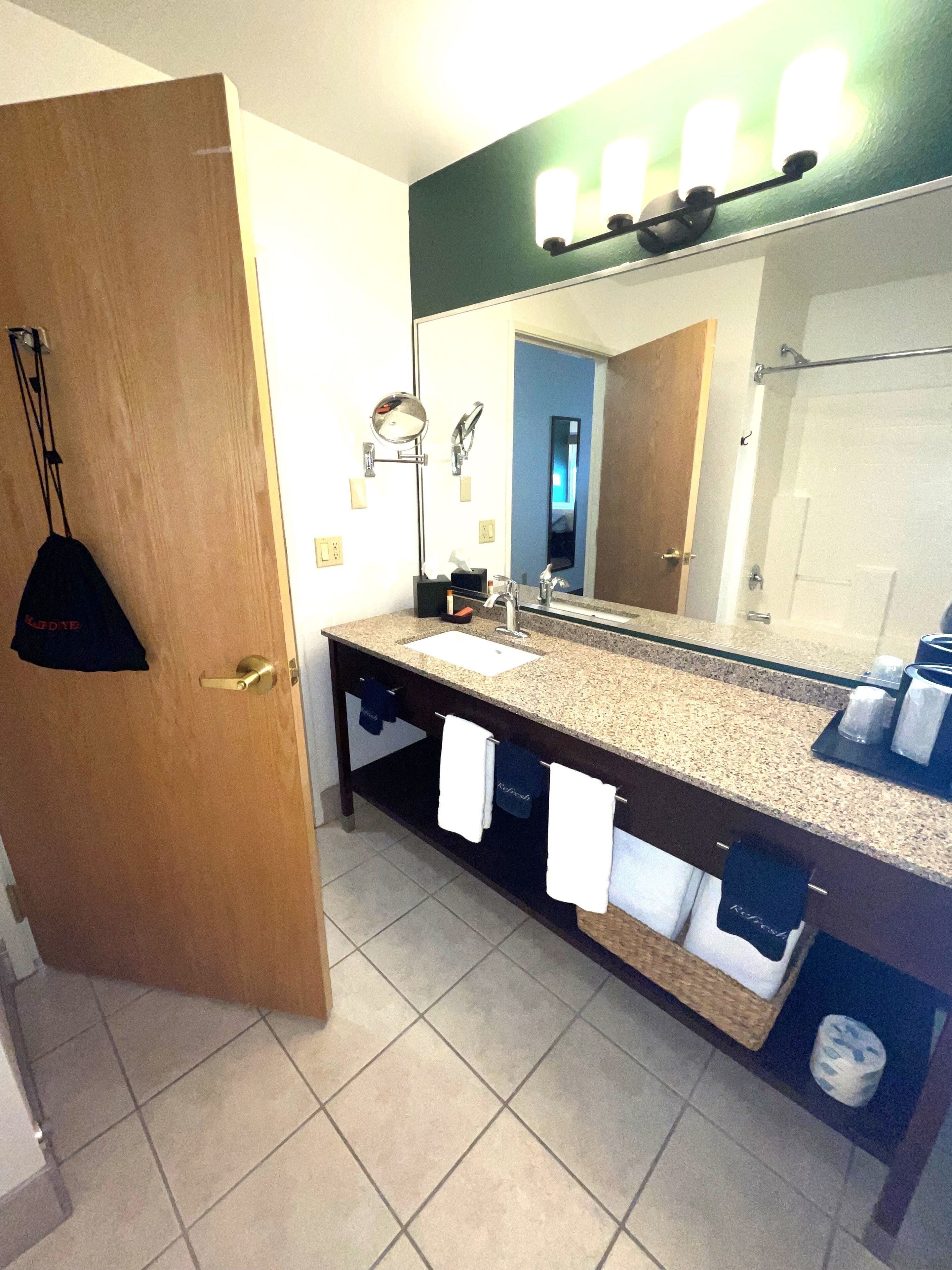 combined shower/bathtub, designer toiletries, hair dryer, towels