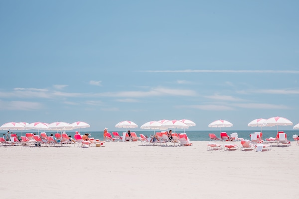 On the beach, white sand, beach cabanas, sun loungers