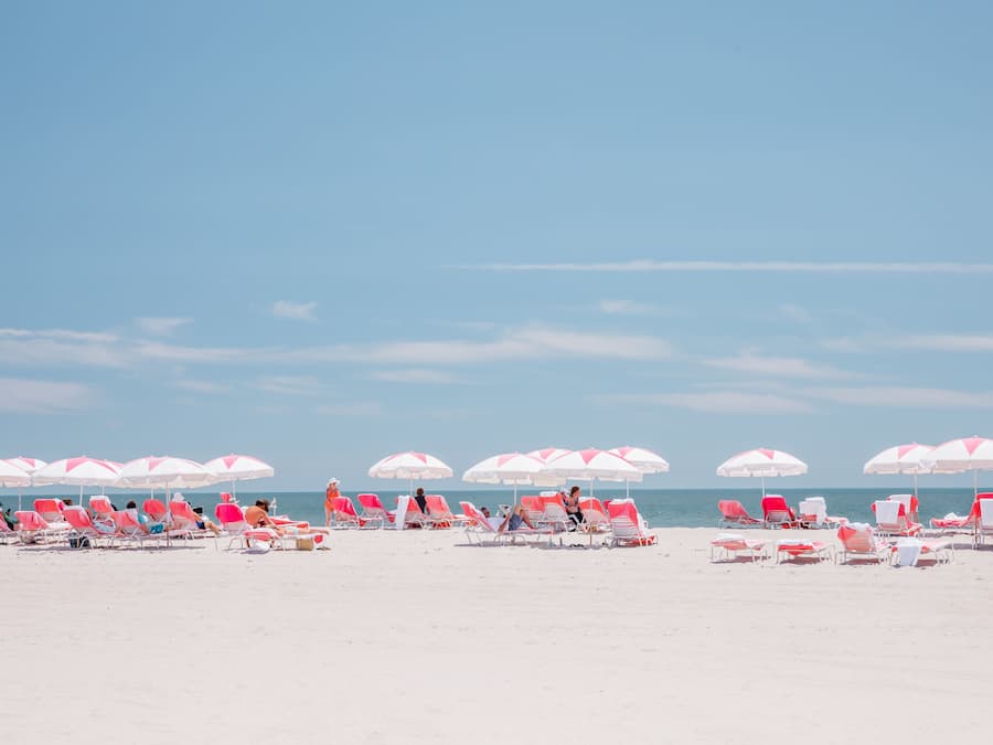 On the beach, white sand, beach cabanas, sun loungers