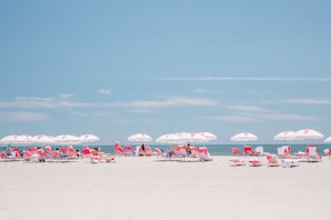 On the beach, white sand, beach cabanas, sun-loungers