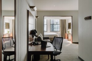 Premium bedding, desk, laptop workspace, blackout drapes