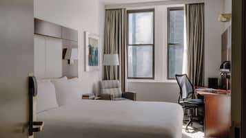 Premium bedding, desk, laptop workspace, blackout drapes